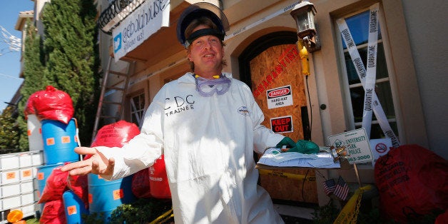 UNIVERSITY PARK, TX - OCTOBER 26: Dallas-area resident James Faulk displays his Ebola-themed Halloween decorations on October 26, 2014 in University Park, Texas. Faulk decorated the front of his house and lawn to resemble the scene of the Dallas apartment where the first U.S. case of Ebola virus was confirmed several weeks ago. Faulk has set up a Twitter account and a website in an effort to raise funds for the Doctors Without Borders charity organization. (Photo by Tom Pennington/Getty Images)