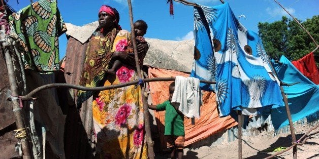 A Somali refugee woman holds a child on October 30, 2014 in the at Sayyid camp south of Mogadishu. UN chief Ban Ki-moon warned on October 30 that Somalia risks returning to famine without urgent aid, as he visited the war-torn country three years since more than 250,000 people died of hunger. AFP PHOTO / Mohamed Abdiwahab (Photo credit should read Mohamed Abdiwahab/AFP/Getty Images)