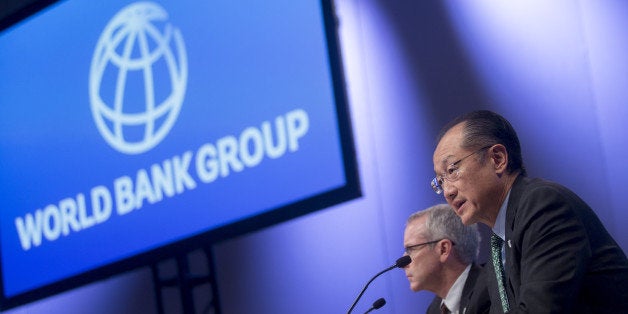Jim Yong Kim, president of the World Bank Group, right, speaks at a news conference during the International Monetary Fund (I