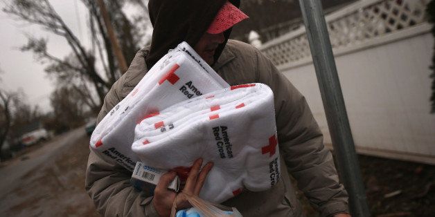 NEW YORK, NY - NOVEMBER 07: Manny Puzzoo carries blankets and other supplies he received from a Red Cross truck near his flood-damaged home on November 7, 2012 in the Staten Island borough of New York City. He and fellow residents of the seaside Midland Beach area of Staten Island braced for a Nor'Easter storm that could potentially re-flood areas devastated by Superstorm Sandy. (Photo by John Moore/Getty Images)