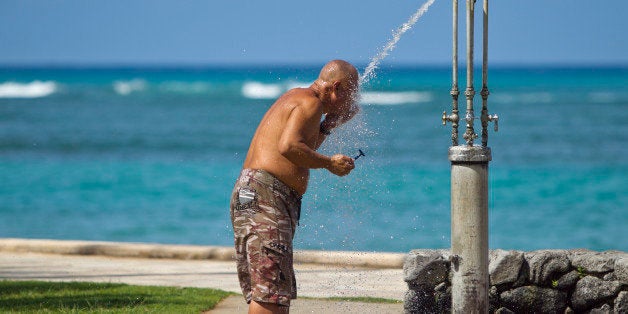 With the blue waters of Waikiki in the background, a man shaves at a public shower at Kapiolani Park, Wednesday, May 11, 2011 in Honolulu. Honolulu is currently grappling with one of nation's most serious homeless challenges as the city prepares to host the Asia Pacific Economic Cooperation conference in November. Homelessness threatens to mar the perfect picture Hawaii would like to present to those attending APEC. (AP Photo/Marco Garcia)