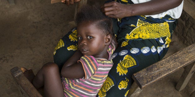 GANTA, LIBERIA October 18: A girl gets her hair braided in the village where Ebola first struck Ganta on October 18, 2014 in Ganta, Liberia. Roseline Tokpah, an Ecobank employee who returned to Ganta after contracting Ebola in the capital city of Monrovia, was the first to die, with her husband and several members of her extended family and village soon following suite, representing the first cases of Ebola in Ganta. Close relations between family and neighbors make it difficult to contain the spread of the virus. (Photo by Tanya Bindra for The Washington Post via Getty Images)