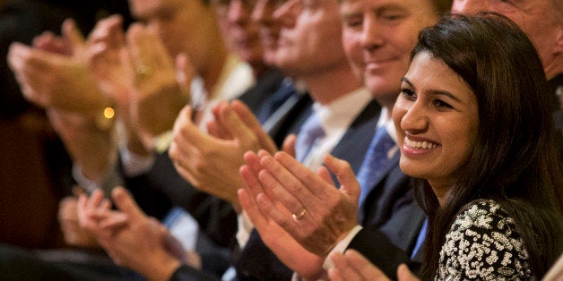 Dutch King Willem Alexander, third from right, and other guests applaud eighteen-year-old American Neha Gupta, right, after the announcement was made that Gupta received the KidsRights Children's Peace Prize in The Hague, Netherlands, Tuesday, Nov. 18, 2014. (AP Photo/Peter Dejong)