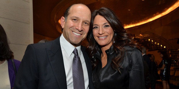 Howard Lutnick, chairman and chief executive officer of Cantor Fitzgerald LP, and wife Allison Lutnick stand for a photograph