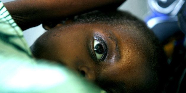 An unidentified child lies on the bed at Trinity Hospital in Sanje district, Nchalo, Malawi, Monday, Sept. 26, 2005. It is estimated that half the children admitted to the intensive feeding ward are HIV positive, complicating efforts to treat their malnutrition. (AP Photo/Obed Zilwa)