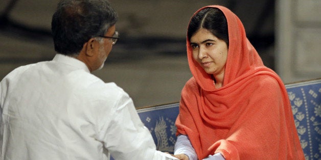 Nobel Peace Prize winners Malala Yousafzai from Pakistan and Kailash Satyarthi of India shake hands during the Nobel Peace Prize award ceremony in Oslo, Norway, Wednesday, Dec. 10, 2014. The Nobel Peace Prize is being shared between Malala Yousafzai, the 17-year-old Taliban attack survivor, and the youngest Nobel Prize winner ever, and Indian children's rights activist Kailash Satyarthi in a ceremony in Oslo on Wednesday. (AP Photo/Matt Dunham)