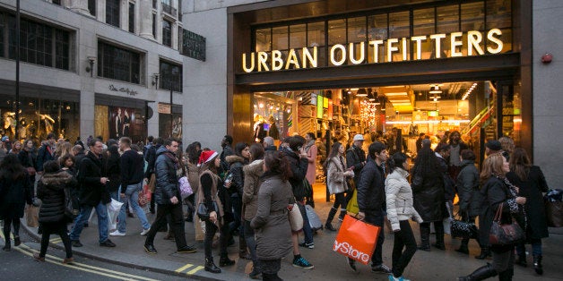 LONDON, ENGLAND - DECEMBER 14: Christmas shoppers walk outside Urban Outfitters on December 14, 2013 in London, England. As Christmas Day approaches, London's central shopping districts attempt to lure shoppers into stores with last minute deals in an effort to pull sales away from online outlets. (Photo by Dan Dennison/Getty Images)