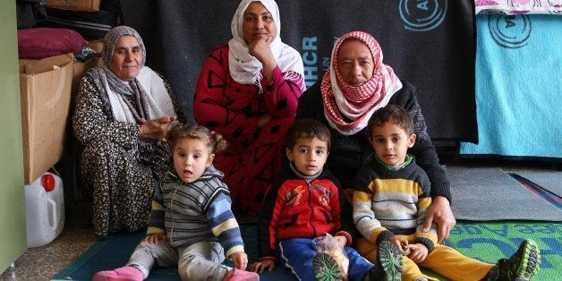 SANLIURFA, TURKEY - DECEMBER 8: Syrians fled from the clashes between Islamic State of Iraq and the Levant (ISIL) and Syrian Kurdish armed groups in Kobani (Ayn al-Arab) city, try to hold on life at Suruc Boarding School in Sanliurfa, southeastern of Turkey on December 8, 2014. (Photo by Binnur Ege Gurun/Anadolu Agency/Getty Images)