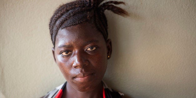 PORT LOKO, SIERRA LEONE NOVEMBER 24: A pregnant Fatmata Kabia, 21, waits for her baby to be born after surviving Ebola in Port Loko, Sierra Leone, on Monday, November 24, 2014. Pregnant women are particularly vulnerable to the disease. (Photo by Nikki Kahn/The Washington Post via Getty Images)