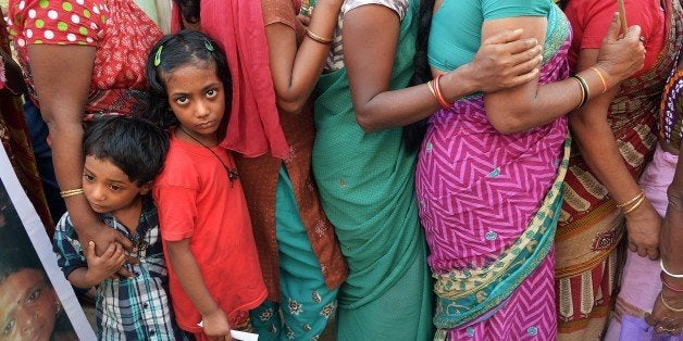 The children of Indian sex workers look on as they participate in a rally at the Sonagachi area of Kolkata on November 8, 2014. Hundreds of sex workers with their children and family members participated in the rally to demand better legal protection of sex workers, claiming that better laws will reduce human trafficking and exploitation. AFP PHOTO/Dibyangshu SARKAR (Photo credit should read DIBYANGSHU SARKAR/AFP/Getty Images)