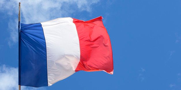 French national flag flying in front of a Government building in Paris.