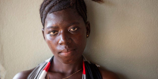 PORT LOKO, SIERRA LEONE NOVEMBER 24: A pregnant Fatmata Kabia, 21, waits for her baby to be born after surviving Ebola in Port Loko, Sierra Leone, on Monday, November 24, 2014. Pregnant women are particularly vulnerable to the disease. (Photo by Nikki Kahn/The Washington Post via Getty Images)