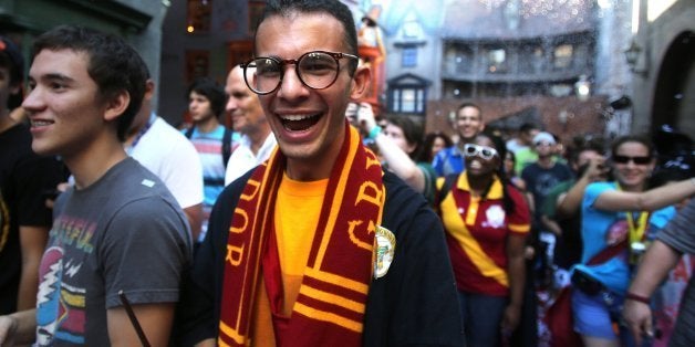 Cheering fans react to being welcomed into a confetti-filled Diagon Alley during the grand opening at the Wizarding World of Harry Potter expansion, at Universal Studios Florida, in Orlando, Tuesday, July 8, 2014. (Joe Burbank/Orlando Sentinel/MCT via Getty Images)