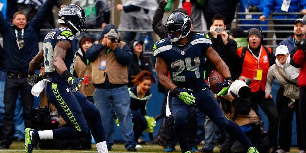 SEATTLE, WA - JANUARY 18: Marshawn Lynch #24 of the Seattle Seahawks gestures after scoring a touchdown against the Green Bay Packers during the 2015 NFC Championship game at CenturyLink Field on January 18, 2015 in Seattle, Washington. (Photo by Kevin C. Cox/Getty Images)