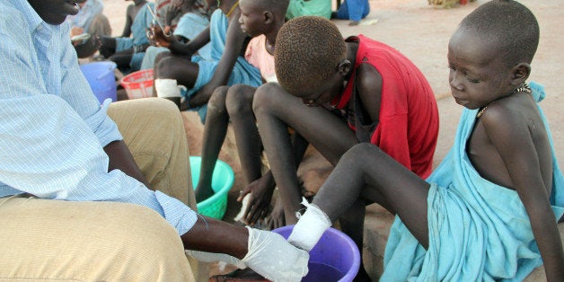 ** TO GO WITH SUDAN CARTER GUSANO ** In this Nov. 4, 2010 photo, Ajak Kuol Nyamchiek, 7, watches while John Lotiki, a nu