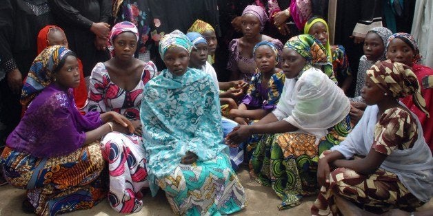 Chibok school girls who escaped from the Boko Haram Islamists gather to receive informations from officials on May 5, 2014. Nigeria's president said on May 8 that Boko Haram's mass abduction of more than 200 schoolgirls would mark a turning point in the battle against the Islamists, as world powers joined the search to rescue the hostages. AFP PHOTO/STR (Photo credit should read STR/AFP/Getty Images)