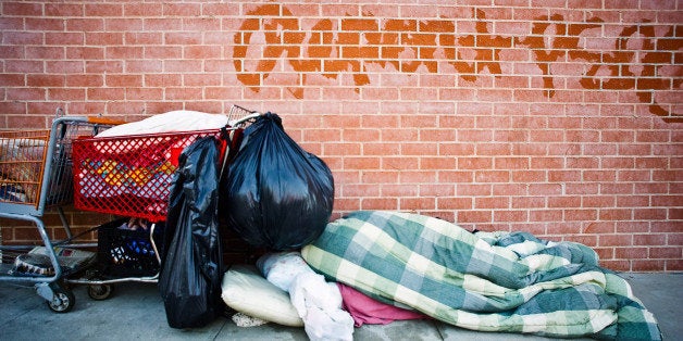 A homeless man makes the sidewalk his dwelling