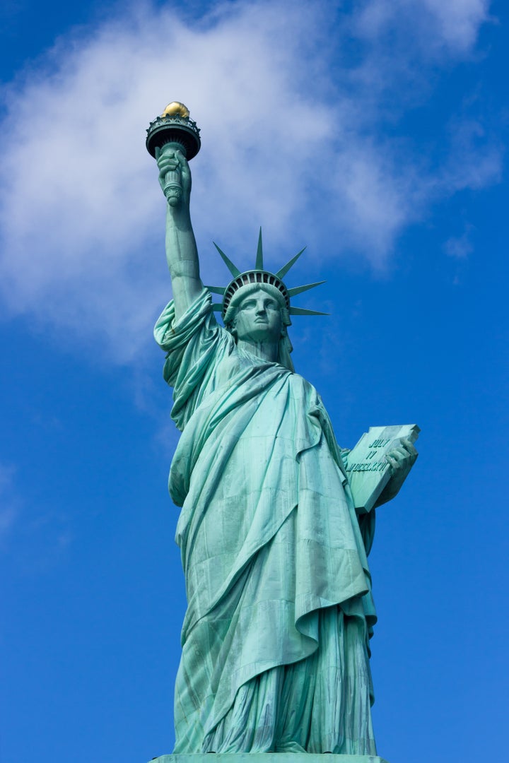 statue of liberty on a cloudy...