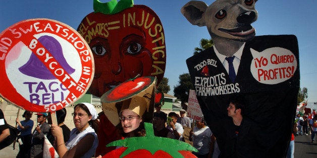 402159 02: Farmworkers, students, and activists march to the corporate offices of Taco Bell March 11, 2002 in Irvine, CA, calling attention to the working conditions of Florida farm laborers who harvest tomatoes for the fast Mexican food chain. The protesters are calling for a boycott to help pressure Foridas growers to improve the pay and conditions of workers, who they say earn about $7,500 a year. (Photo by David McNew/Getty Images)