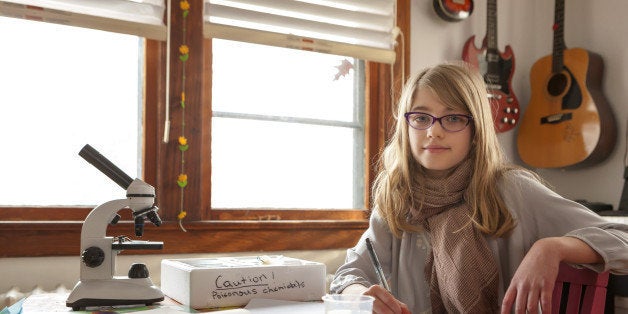 Portrait of young girl in playroom studying science