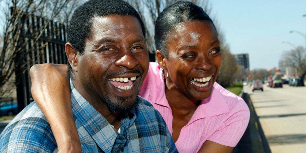 In this Thursday, March 17, 2011 photograph, former Tent City resident Marvin Tomlinson is hugged by girlfriend Alvia Partlow, as he sits on a curb in Camden, N.J. Tomlinson says for him Tent City was a real home, a place where he had responsibilities like chopping wood and starting the fire for the camp cooks. "You always had somebody to talk to," says Tomlinson. "We were a close-knit family." A year after the closing of Tent City, some of the former homeless have found homes, and happiness, though others are following twists and turns that originally led them to the streets. (AP Photo/Mel Evans)