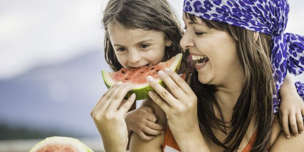 Mother and daughter eating watermelon