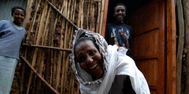 ADDIS ABABA, ETHIOPIA - JULY 13: Kelbe Adamu (C) is enjoying a nice moment with her family, in this case two cousins, in the alley in front of her house inside the slum for lepers of Addis Ababa July 13, 2007 in Addis Ababa, Ethiopia. (Photo by Jonathan Alpeyrie/Getty Images)