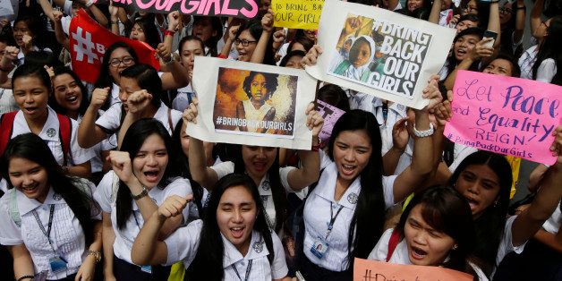 Students from St. Scholastica's College, a Catholic school in Manila, shout slogans during a protest outside their campus Friday, June 27, 2014 in Manila, Philippines. Thousands of Filipino students from the Roman Catholic-run school for girls joined Friday a global campaign to free more than 200 schoolgirls abducted by Islamic extremists in Nigeria, chanting "bring them back" and urging motorists in the Philippine capital to honk their car horns in solidarity. (AP Photo/Bullit Marquez)