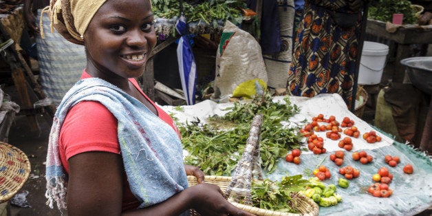 Woman showing the basket of the purchase on the market of Zidanchor's African city, Senegal