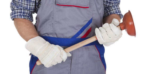 Portrait Of Male Plumber Holding Plunger isolated Over White Background