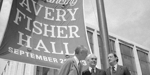 Avery Fisher, center, founder of Fisher Radio, stands in front of the former philharmonic hall in New York Lincoln center on Sept. 20, 1973 after it was renamed in his honor. The hall was renamed after Fisher contributed what was said to have been millions of dollars for the maintenance of the hall and aid for young performers. With Fisher are Amyas Ames, left, chairman of the New York Philharmonic, which performs in the hall, and John Mazola, right, managing director of Lincoln center. (AP Photo/Richard Drew )