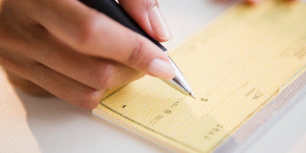 Cape Verdean woman writing a check