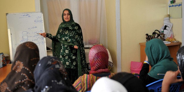 This picture taken in Kabul on October 12, 2011 shows Afghan women attending a computing class at a shelter run by women for Afghan women. In the war-torn country, Afghan women often oppressed by poverty, family disputes, forced marriage or discrimination. Women's right in Afghanistan risk being forgotten as international troops withdraw and the government struggles for a peace deal 10 years after the Taliban were ousted, report by Oxfam and ActionAid said. AFP PHOTO / ADEK BERRY (Photo credit should read ADEK BERRY/AFP/Getty Images)