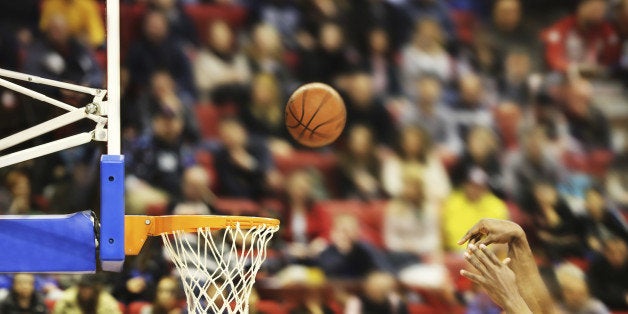 Scoring the winning points at a basketball game , motion blur