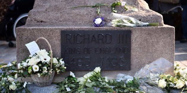 Floral tributes are pictured as members of the public queue to view the coffin containing the remains of England's King Richard III in Leicester Cathedral in Leicestershire on March 23, 2015, ahead of a reburial some 530 years on from his violent death in 1485 at the Battle of Bosworth. Tens of thousands lined the streets on Sunday to see the coffin of England's Richard III taken in procession to his final burial, five centuries after his battlefield death. AFP PHOTO / BEN STANSALL (Photo credit should read BEN STANSALL/AFP/Getty Images)