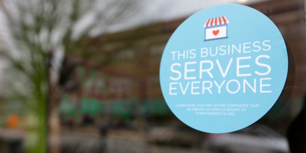 A window sticker on a downtown Indianapolis business, Wednesday, March 25, 2015, shows its objection to the Religious Freedom bill passed by the Indiana legislature. Organizers of a major gamers' convention and a large church gathering say they're considering moving events from Indianapolis over a bill that critics say could legalize discrimination against gays. (AP Photo/Michael Conroy)