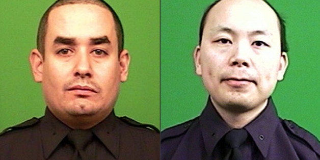 FILE - This combination made from photos provided by the New York Police Department shows officers Rafael Ramos, left, and Wenjian Liu. President Barack Obama has signed into law a measure allowing people to write off donations they made this year to the families of the two slain New York police officers. Under normal circumstances, individuals would have had to donate to the families by Dec. 31 to quality for a deduction on their 2014 taxes. The legislation extends that deadline until April 15, 2015, the deadline for Americans to file their personal income taxes. (AP Photo/New York Police Department, File)