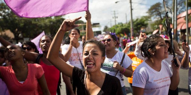 Women from various women's rights organizations shout anti-government slogans during a march in commemoration of International Women's Day in Managua, Nicaragua, Sunday, March 8, 2015. (AP Photo/Esteban Felix)