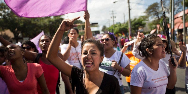 Women from various women's rights organizations shout anti-government slogans during a march in commemoration of Internationa