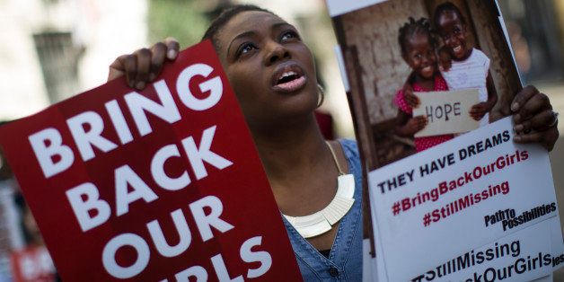 LONDON, ENGLAND - APRIL 14: A woman holds a sign as other protesters gather outside Nigeria House to mark the one year anniversary since a group of Nigerian schoolgirls were abducted on April 14, 2015 in London, England. Two hundred and seventy-six schoolgirls were abducted from their boarding school on 14 April, 2014 in the town of Chibok in north-eastern Borno state in Nigeria. The abductions sparked protests around the world calling for the release of the girls who continue to be held by the militant group Boko Haram. (Photo by Dan Kitwood/Getty Images)