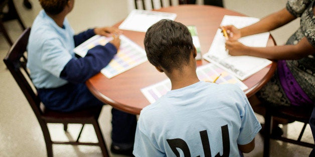 Juvenile residents sit at a table in a new career guidance center at the Department of Juvenile Justice's Metro Regional Yout