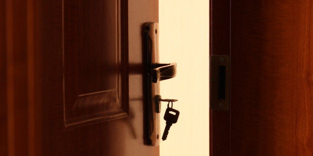 The door is openning,a key is inserted in lock.