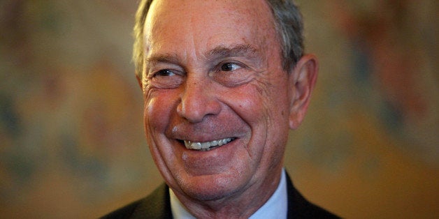 FILE - In this Sept. 16, 2014, file photo, former New York Mayor Michael Bloomberg smiles prior to be conferred with the Chevalier de la Legion d'Honneur by France's Foreign minister Laurent Fabius, at the Quai d'Orsay, in Paris. A Department of Investigation probe is finding that New York Cityâs effort to modernize its 911 system is years behind schedule and $700 million over budget. The probe released Friday, Feb. 6, 2015, lays the blame at the feet of the former mayor's administration. (AP Photo/Thibault Camus, File)