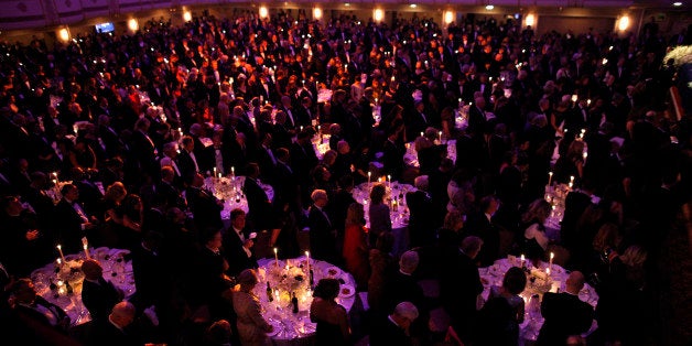 Audience members stand at the 67th annual Alfred E. Smith Memorial Foundation Dinner, a charity gala organized by the Archdiocese of New York, attended by President Barack Obama and Republican presidential candidate and former Massachusetts Gov. Mitt Romney, Thursday, Oct. 18, 2012, at the Waldorf Astoria hotel in New York. (AP Photo/Charles Dharapak)