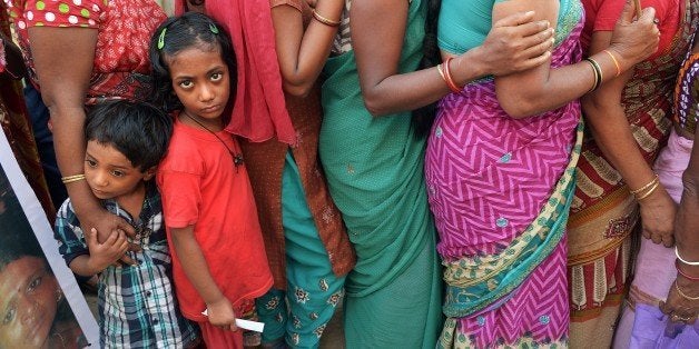 The children of Indian sex workers look on as they participate in a rally at the Sonagachi area of Kolkata on November 8, 201