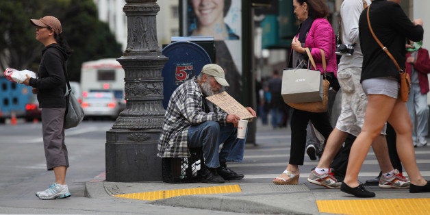 SAN FRANCISCO - SEPTEMBER 16: A homeless man holds a sign as he panhandles for spare change on September 16, 2010 in San Fra