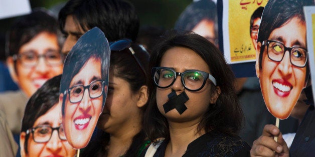 Supporters of prominent women's rights activist Sabeen Mahmud, who was killed by unknown gunmen, hold her pictures during a rally, Tuesday, April 28, 2015, in Islamabad, Pakistan. Gunmen on a motorcycle killed Mahmud last Friday in Pakistan just hours after she held a forum on the country's restive Baluchistan region, home to a long-running insurgency, police said. (AP Photo/B.K. Bangash)