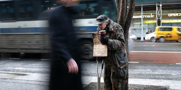 A homeless man begs for donations outside a subway station in New York on February 4, 2015. New York may be famous abroad for glitz, glamor and Park Avenue billionaires but America's biggest city has passed a grim milestone -- a record 60,000 people are homeless. In November, there were 60,352 homeless people in the city, including 25,000 children, up more than 10 percent on the 53,615 who were homeless in January 2014, according to the website for charity Coalition for the Homeless. AFP PHOTO/JEWEL SAMAD (Photo credit should read JEWEL SAMAD/AFP/Getty Images)