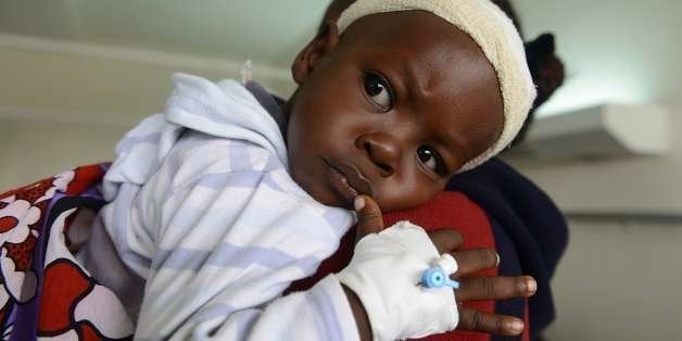 18-month-old boy Satrin Osinya (R) is pictured as he receives treatment at the Kenyatta National hospital in Nairobi on March 26, 2014 , three days after gunmen spraying bullets on the congregation killed six worshipers and injured 17 others during a worship service in the Coastal city of Mombasa. The fate of one-and-a-half-year-old Satrin Osinya, whose mother died trying to protect him when the attackers sprayed the church service with bullets, has gripped the east African nation. Doctors will likely wait for two weeks until swelling in the brain reduces to allow the tricky surgery to go ahead. AFP PHOTO/SIMON MAINA (Photo credit should read SIMON MAINA/AFP/Getty Images)