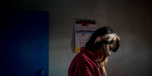 KATHMANDU, NEPAL - MAY 14: At Mati Nepal's office at the Thankot Checkpoint, the Mati Nepal's staff and the police interrogate a young woman who is under suspicion to be a victim of human trafficking, on May 14, 2015 in Kathmandu, Nepal. After the devastating magnitude 7.8 earthquake of April 25, entire villages were destroyed and hundreds of thousands of people were made homeless and children orphaned. Some of these remote areas have long been targeted by human-traffickers seeking young women and girls and the current situation has significantly increased the risk to women and children. The NGO 'Mati Nepal', based in Kathmandu, is working tirelessly to protect girls and women and prevent them become victims of traffickers. (Photo by Jonas Gratzer/Getty Images)